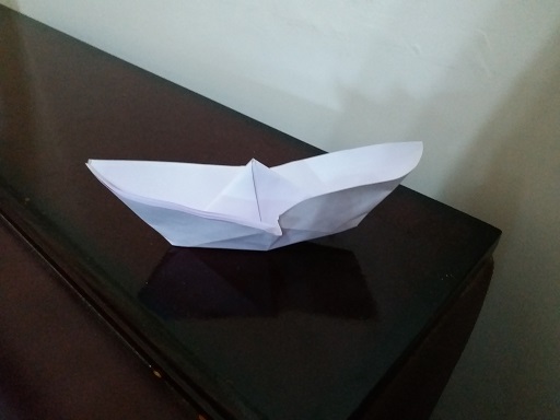 Paper boat in rain